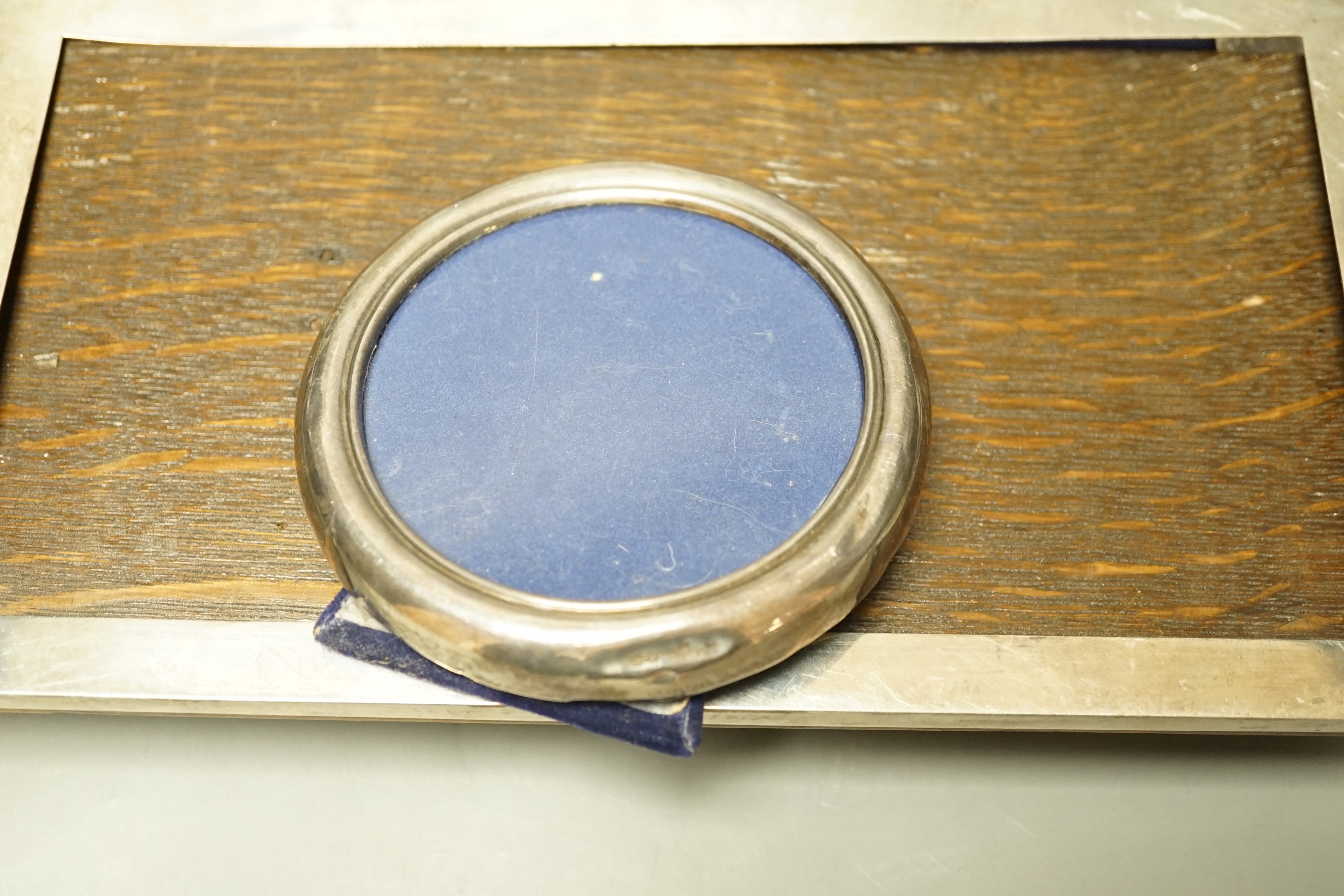 A George V large planished silver mounted rectangular photograph frame, E. Mander & Son, Birmingham, 1912, 33cm and two other silver mounted photograph frames.